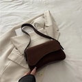 Minimalist chocolate brown suede shoulder bag featuring a sleek curved base design - Brown