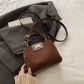 Dark brown retro crossbody handbag with matte suede texture and gold twist lock - Brown
