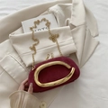 Burgundy suede mini evening bag with a large gold oval metal handle and chain strap - Red