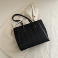 Black quilted tote bag with square stitching and slim leather straps for commute - Black