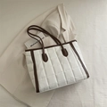 Quilted white tote bag with dark brown handles and padded cotton fabric texture - White