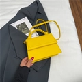 Minimalist bright yellow top-handle crossbody bag with elegant twisted knot detail - Yellow