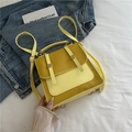 British style yellow backpack in woven leather with golden button details and top handle - Yellow