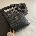 Black and grey bucket bag with M-letter print and geometric patterned shoulder strap - Black