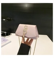 Pink glossy mini crossbody bag featuring golden letter logo and metallic tassel detail - Pink