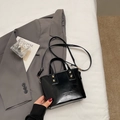 Borsa a secchiello nera lucida in pelle PU con tracolla e dettagli in metallo oro - Nero