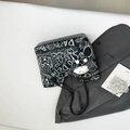 Black tote bag with white graffiti prints and long leather straps on gray blazer - Black With Pendant