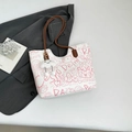 White graffiti tote bag with pink patterns, brown straps and cloud charm accessory - Pink With Pendant