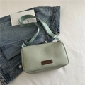 Light green nylon crossbody bag with fashion label on denim jacket background - Green