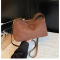 Detail of brown suede crossbody bag showing soft texture and gold-tone zipper hardware - Brown