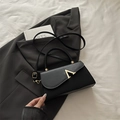 Structured black leather handbag with gold V-clasp and removable crossbody strap - Black