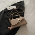 Khaki evening square bag with gold V-clasp and adjustable strap on black blazer - Khaki