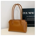 Detailed side view of a minimalist brown leather tote bag with long shoulder straps - Brown