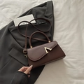 Dark brown leather shoulder bag with gold V-buckle accent and top handle for evening wear - Brown