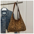 Detail of vintage leopard print tote bag hanging with dark denim jacket background - Leopard Brown