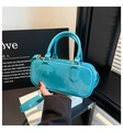 Detail of bright blue patent leather bag with a mirror finish and cylinder design - Blue