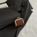 Brown lychee texture mini coin purse with vintage gold clasp on a grey blazer - Brown