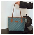 Dettaglio della borsa tote in nylon trapuntato con motivo a rombi e manici in cuoio - Verde