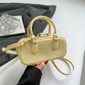 Pale yellow glossy jelly shoulder bag with cylindrical handles and gold hardware - Yellow