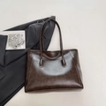 Deep brown faux leather tote bag with a minimalist design and spacious interior for commuting - Brown