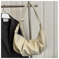 Detail of a beige pleated crescent bag made of soft PU leather on a stainless steel hanger - Off White