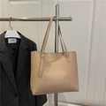 Large beige leather tote bag with long straps and gold buckle displayed on a hanger - Khaki