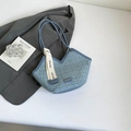 Blue tweed tote bag with V-shaped opening and white decorative strap on white surface - Blue