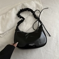Glossy black crescent shoulder bag with pleated handle and fashion typography detail - Black