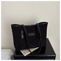 Detailed view of black corduroy tote bag with FANYISSA leather label and golden rivet strap - Black