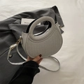 Silver-grey woven handbag with round cutout handle and adjustable gold strap - Silver