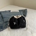 Black quilted tote bag with white embroidery and beige drawstring closure - Black