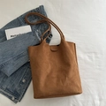 Brown faux suede large tote bag with top handle, styled with denim jacket and book - Brown