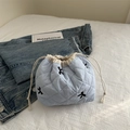 Light blue quilted drawstring makeup bag with black bow embroidery and cloud-like texture - Blue