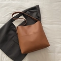 Minimalist caramel brown bucket tote bag with vertical stitching and shoulder strap - Tan