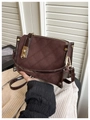 Detail view of dark coffee vintage crossbody bag with diamond quilted stitching and gold lock - Coffee