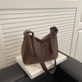 Brown leopard print tote bag with wide shoulder strap displayed on a white decorative book - Brown