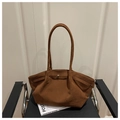 Detail view of large brown suede tote bag resting on chair for minimalist commute style - Brown