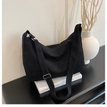 Detail of minimalist black canvas crescent bag with adjustable strap and smooth zipper - Black