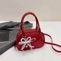Red oval bowling handbag with pearl bow lace pendant and adjustable shoulder strap - Red with Pendant