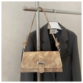 Detail of vintage camel shoulder bag with silver buckle and knotted strap on display - Khaki