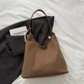 Brown suede hobo shoulder bag with beaded tassel charm on a neutral background - With Pendant / Brown