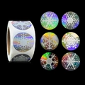 Roll of holographic silver snowflake stickers with Merry Christmas design on black background - Laser Snowflake Style