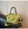 Detalle de bolso cubo de nailon verde con asa de cuerda y etiqueta de marca transparente - Verde