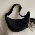 Minimalist black crescent crossbody bag in durable nylon with an adjustable strap - Black