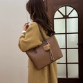 Brown faux leather tote bag with plush bear charm and slender shoulder straps - Brown