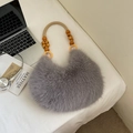 Grey faux fur dumpling bag with wooden bead handle and minimalist aesthetic style - Gray