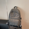 Deep grey quilted backpack with soft puffer texture and branded shoulder straps - Gray