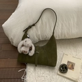 Detail of dark olive green crescent bag in matte suede with a plush rabbit charm - Green with Pendant