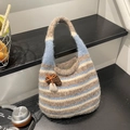 Knitted striped bucket bag in blue and beige with a mushroom charm and top handle - Blue