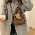 Brown lychee leather bucket bag with plush bear charm and detachable crossbody strap - With Charm / Brown